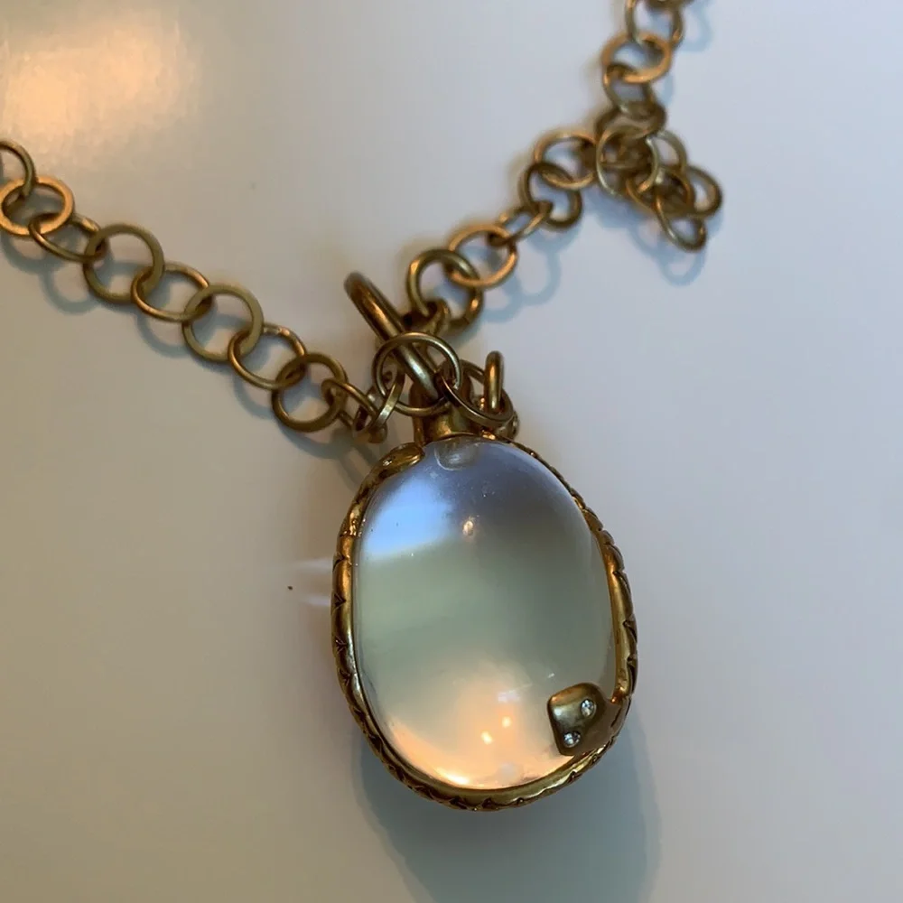 Vintage golden Snake wrapped around an elongated oval crystal